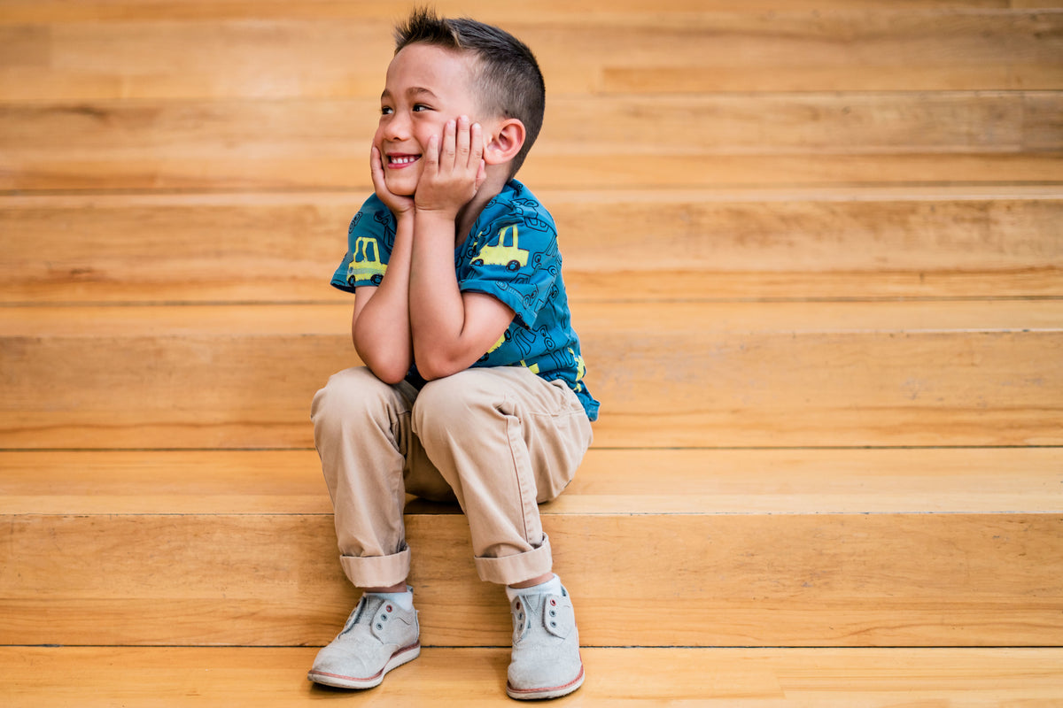 Smiling child sitting on wooden steps